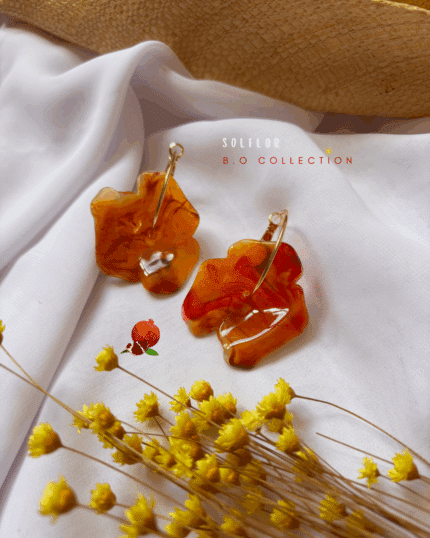 Boucle d'oreilles avec fleur en résine coloris orange marbré Diamètre fleur : 4 cm Créole en plaqué or