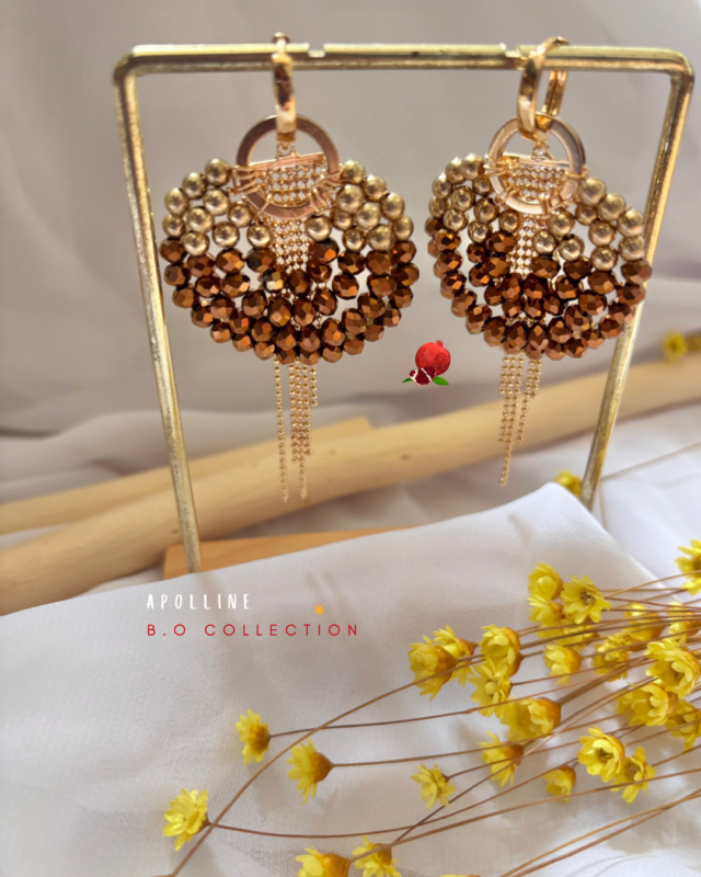Boucle d’oreille pendante composée de perles à facettes (coloris chocolat) de forme ronde et d’une pampille Clou d’oreille créole en acier inoxydable Longueur totale : 7 cm Poids : 7grs